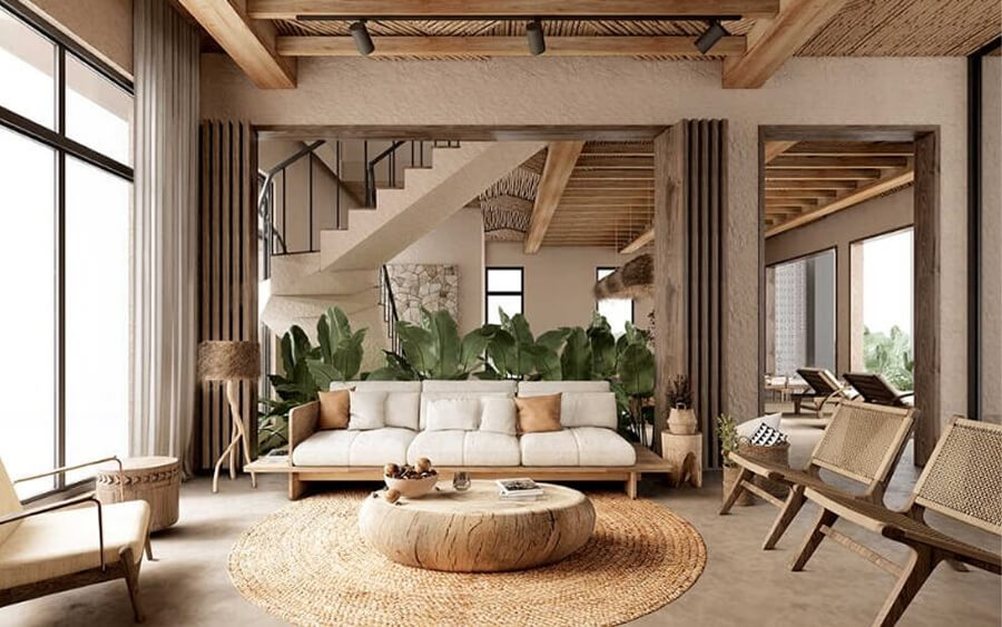 Phòng khách biệt thự Địa Trung Hải với sofa nỉ màu kem, bàn gỗ tròn thô mộc và trần gỗ lộ xà đặc trưng